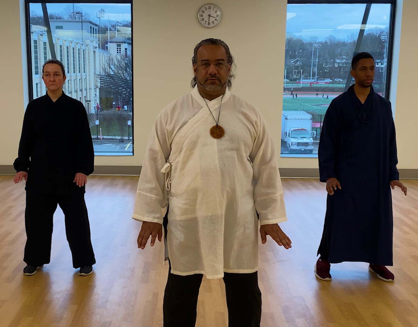 Instructor teaching martial arts forms to dedicated students. DaShiFu Marc Phillip Black and students at the commencement of TaiJi (Tai Chi)