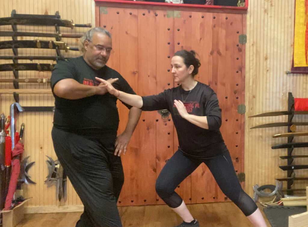 Master and student practice Tui Shou, or push hands, together.