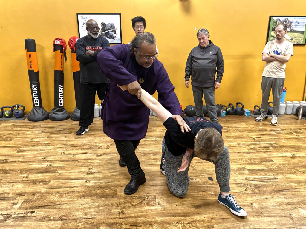 Kung Fu instructor demonstrating martial technique to adult students in Pittsburgh PA.