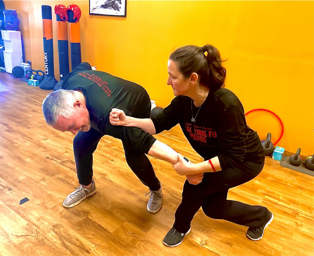 Martial arts students practicing realistic combat drills at Black Mountain Spirit martial arts school in Pittsburgh.