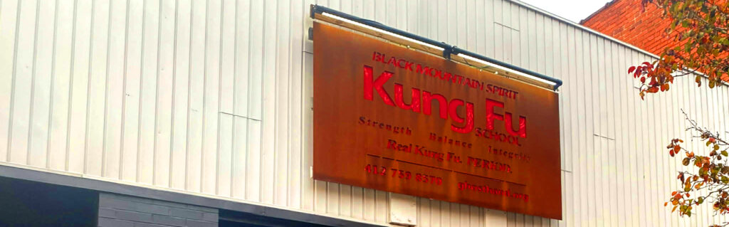 Entrance of Black Mountain Spirit martial arts school Pittsburgh featuring Real Kung Fu Period slogan.
