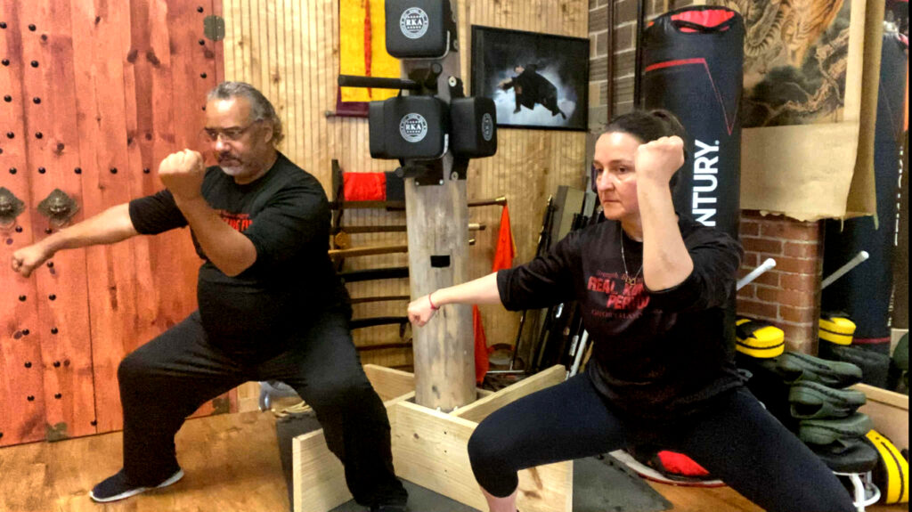 Martial arts instructor teaching adult student Kung Fu movement at Black Mountain Spirit Pittsburgh.